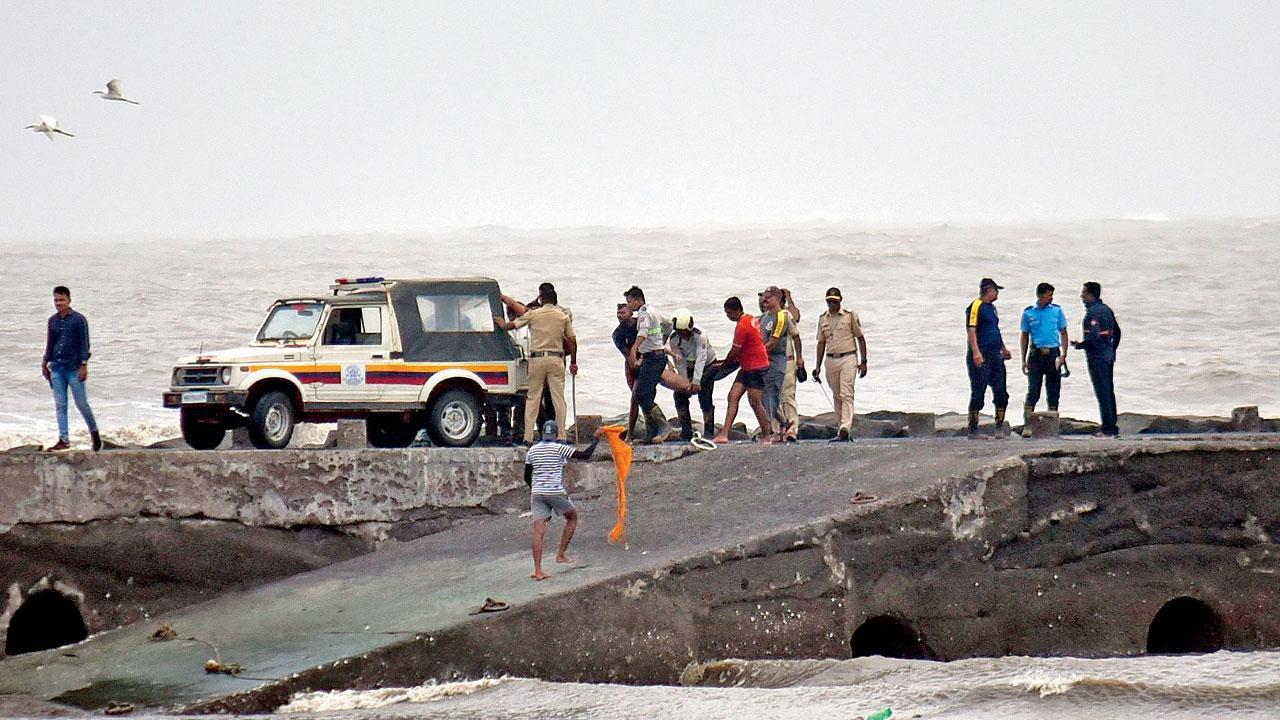 ગઈ કાલે સવારે દરિયામાંથી મળેલા એક ટીનેજરના મૃતદેહને લઈ જતા પોલીસ અને ફાયરબ્રિગેડના જવાનો  (તસવીર : શાદાબ ખાન)