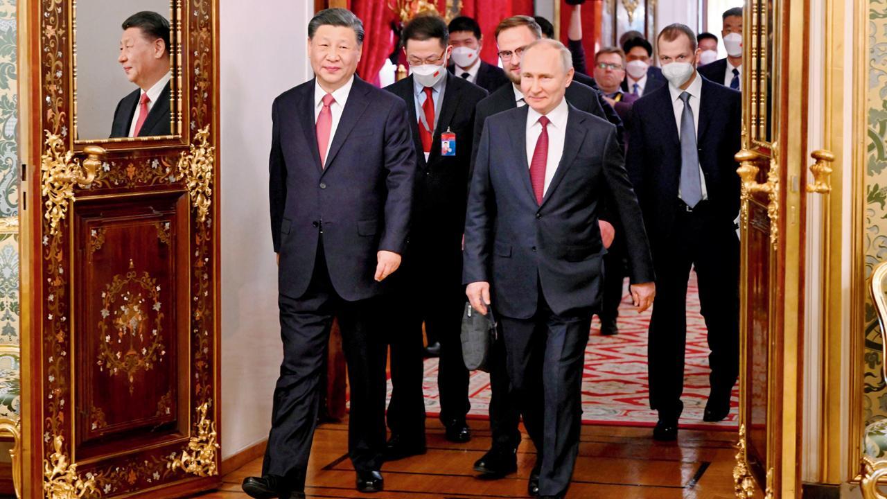 રશિયાના મૉસ્કોમાં ગઈ કાલે ક્રેમલિનમાં ધ ગ્રૅન્ડ ક્રેમલિન પૅલેસના હૉલમાં પ્રવેશી રહેલા રશિયન પ્રેસિડન્ટ વ્લાદિમીર પુતિન અને ચીનના પ્રેસિડન્ટ શી જિનપિંગ. તસવીર એ.પી./પી.ટી.આઇ.