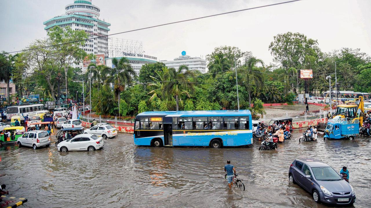 પટનામાં ગઈ કાલે ભારે વરસાદ બાદ પાણી ભરાયેલા માર્ગ પરથી પસાર થઈ રહેલા લોકો. તસવીર પી.ટી.આઇ.