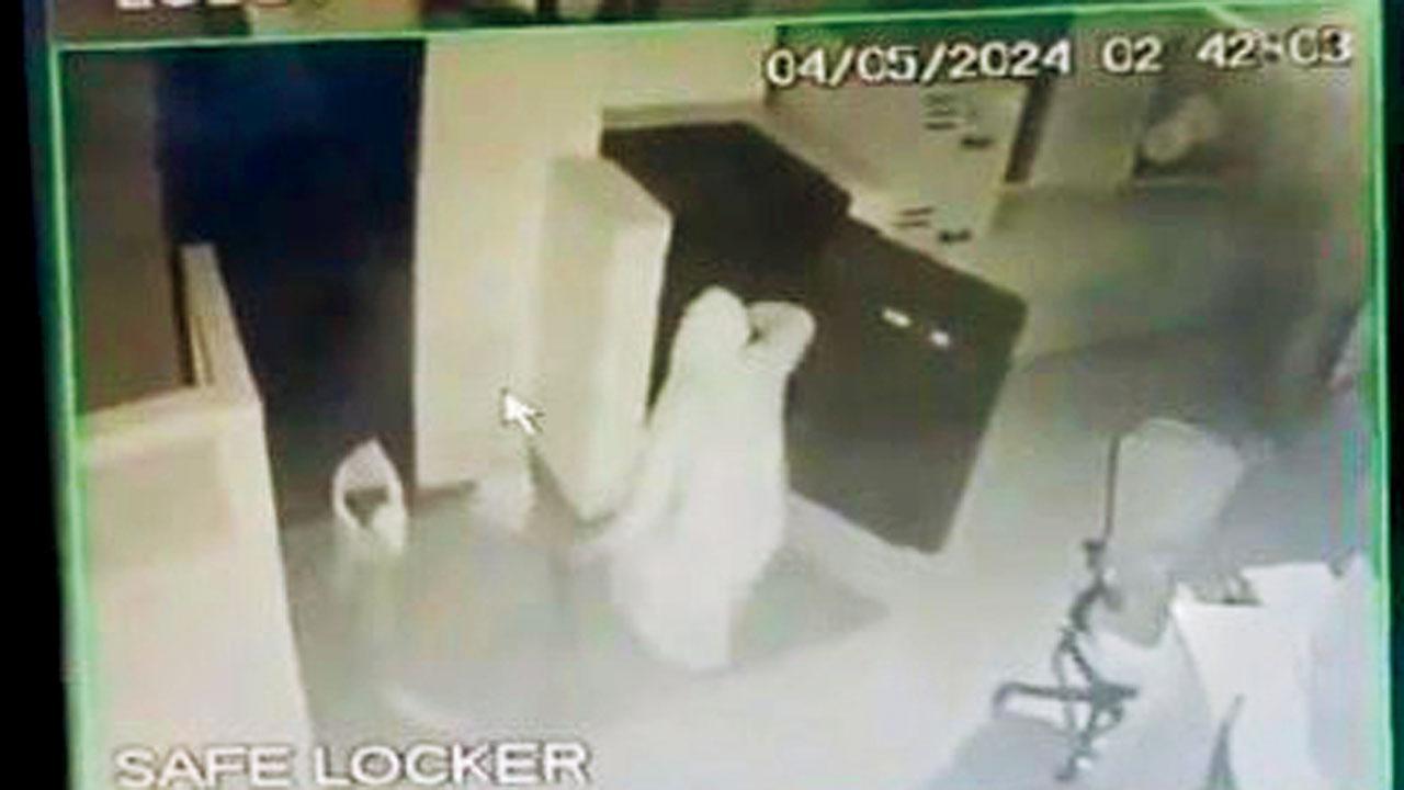 બૅન્કનું લૉકર ખોલીને દાગીના તફડાવી રહેલા તસ્કરનો વિડિયો-ગ્રૅબ.