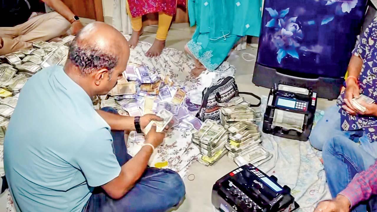 માઇનિંગ ઑફિસરના ઘરેથી પકાડાયેલી રોકડ ગણતા વિજિલન્સ અધિકારીઓ.